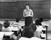 Female teacher teaching students in a classroom Poster Print
