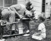 Close-up of a father repairing a toy car with his son sitting in front of him Poster Print - Item # VARSAL2551395A
