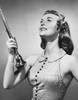 Drum majorette holding a twirling baton and smiling Poster Print - Item # VARSAL25522438