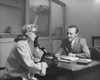 Businessman talking to a mid adult woman in an office Poster Print - Item # VARSAL25528106