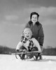 Boy pushing his brother on a sled Poster Print - Item # VARSAL2554997