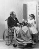 Girl giving a bouquet of flowers to her grandfather sitting in a wheelchair Poster Print - Item # VARSAL25534604A