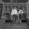 Young couple on steps outside university Poster Print - Item # VARSAL255418384
