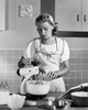 Young woman using an egg beater in a domestic kitchen Poster Print - Item # VARSAL2554585B