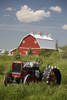 Old Red Tractor In A Field With A Red Barn In The Background; Alberta, Canada PosterPrint - Item # VARDPI1882122