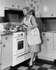 Young woman preparing food in the kitchen Poster Print - Item # VARSAL25536207