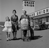 Parents and kids walking across supermarket parking lot with shopping Poster Print - Item # VARSAL255417556