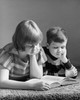 Boy and his sister reading a book Poster Print - Item # VARSAL25516395