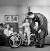 Parents with their son and daughter in a living room Poster Print - Item # VARSAL255317