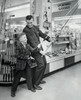 Mature man and boy holding fishing rods in store Poster Print - Item # VARSAL25543682