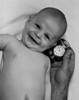 Smiling baby and hand of adult man holding watch Poster Print - Item # VARSAL255419287