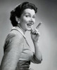 Portrait of a mid adult woman pointing with her finger and smiling Poster Print - Item # VARSAL25511559