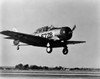 Military airplane landing on a runway Poster Print