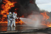 December 7, 2011 - Aircraft Rescue and Firefighting Marines push forward continuing to fight back the flames of a training fire during a pit fuel fires training exercise at the burn pit Poster Print - Item # VARPSTSTK105242M