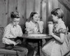Boy sitting with two girls in a restaurant and counting money Poster Print - Item # VARSAL2551000