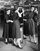 Young woman trying on clothes in a clothing store and a mid adult woman helping her Poster Print - Item # VARSAL2556404