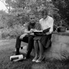 Young couple reading books in garden Poster Print - Item # VARSAL255416413
