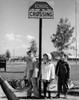 Boys and girl standing near School Crossing sign Poster Print - Item # VARSAL2557198