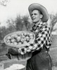 Side profile of a mid adult man holding a basket of apples Poster Print - Item # VARSAL25531433