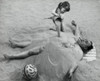 High angle view of a girl burying her father in sand on the beach Poster Print - Item # VARSAL2557994