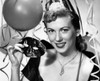 Portrait of beautiful young woman holding carnival mask with balloons and streamers in background Poster Print - Item # VARSAL25517813