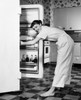 Side profile of a young woman standing in front of a refrigerator Poster Print - Item # VARSAL2555355