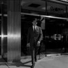 Businessman walking out of office building Poster Print - Item # VARSAL255422697