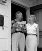 Smiling senior couple standing at front door  holding letters Poster Print - Item # VARSAL25548920