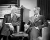 Two businessmen talking indoors Poster Print