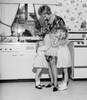 Mother embracing daughters in kitchen Poster Print - Item # VARSAL255417657