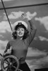 Woman wearing sailor hat at helm of ship Poster Print - Item # VARSAL255422890