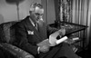 Man reading report in chair Poster Print
