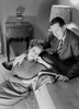 Young couple reading magazine in living room Poster Print - Item # VARSAL255420115