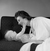 Mother with baby boy on sofa Poster Print - Item # VARSAL255417640B