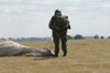 A member of the Pathfinder Platoon collapses his parachute after a HALO jump Poster Print - Item # VARPSTACH100018M