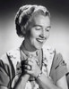 Mid adult woman smiling with her hands clasped Poster Print - Item # VARSAL25511395C