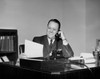 Mature businessman talking on telephone in office Poster Print - Item # VARSAL25548241