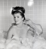 Portrait of young woman scrubbing back in bath Poster Print - Item # VARSAL255418371