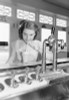 Portrait of young woman drinking milkshake at bar counter Poster Print - Item # VARSAL255422976