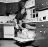 Mature housewife washing dishes in dishwasher Poster Print - Item # VARSAL255417732