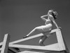 Low angle view of woman sitting on wooden fence Poster Print - Item # VARSAL255419767
