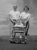 Young parents with child sitting in baby carriage Poster Print - Item # VARSAL2553818B