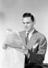 Young man reading newspaper Poster Print - Item # VARSAL255422923