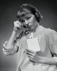 Close-up of a young woman holding a postcard Poster Print - Item # VARSAL25542102