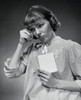 Close-up of a young woman holding a postcard Poster Print - Item # VARSAL25542102