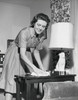 Mid adult woman cleaning a side table Poster Print - Item # VARSAL25541928