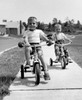 Two boys riding tricycles along path Poster Print - Item # VARSAL2552263