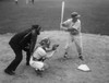 Baseball player swinging a baseball bat with a baseball catcher and a baseball umpire beside him Poster Print - Item # VARSAL2556800