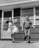 Girl running with her brother and smiling Poster Print - Item # VARSAL25516314