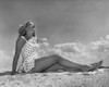 Low angle view of a young woman sunbathing on the beach Poster Print - Item # VARSAL25521111A